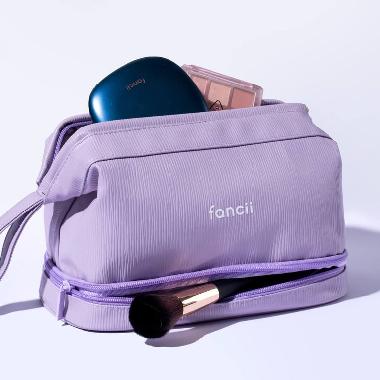 Macy 2-in-1 Makeup Bag by Fancii & Co. in Purple open with accessories sticking out. 
