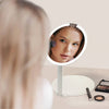 Abigail Travel Mirror from Fancii & Co. Hero Woman Using with lights on White No 10x Magnifying Mirror