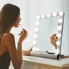 Madeline Bluetooth Mini-Hollywood Vanity Mirror by Fancii & Co.  In use by model.