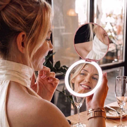Model looks in Taylor Lighted Compact and sees her whole face