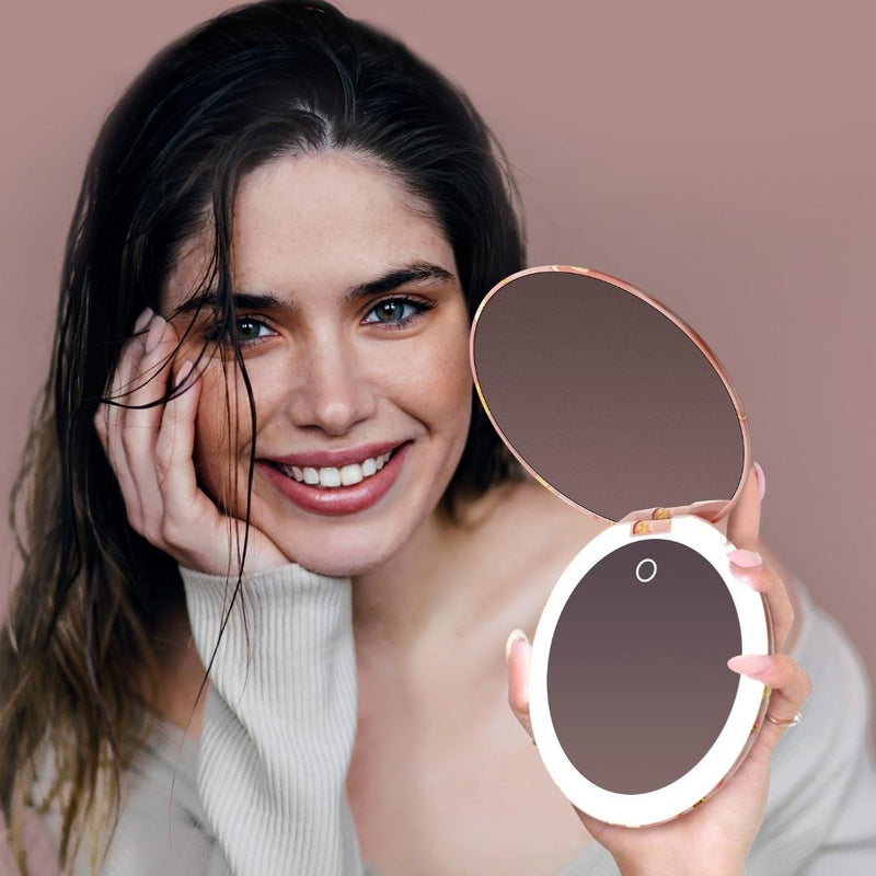 Taylor Lighted Compact with 10x Magnification by Fancii & Co. open and lit up held by model in MARBLE ROSÈ