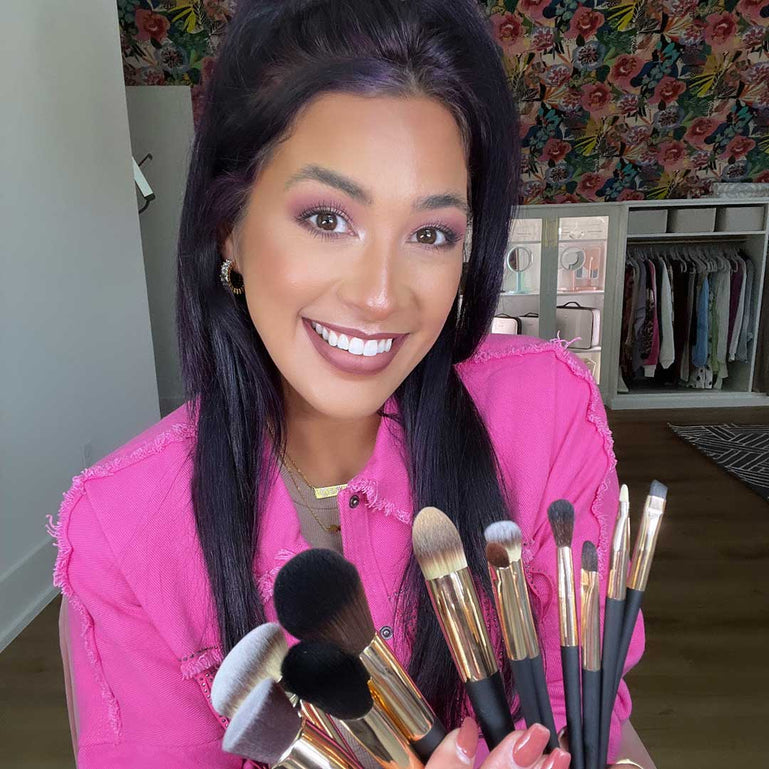 Woman with the ARIA makeup brush set by Fancii and Co All