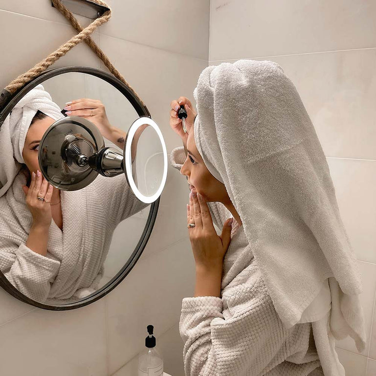 Woman using Fancii Lana 10x magnifying mirror with lights in ChromeWoman using Fancii Lana 10x magnifying mirror with lights in Chrome