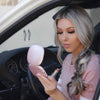 Woman holding Mila lighted compact mirror in Pink