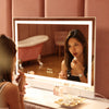 Woman using the Monroe hollywood mirror with lights by Fancii