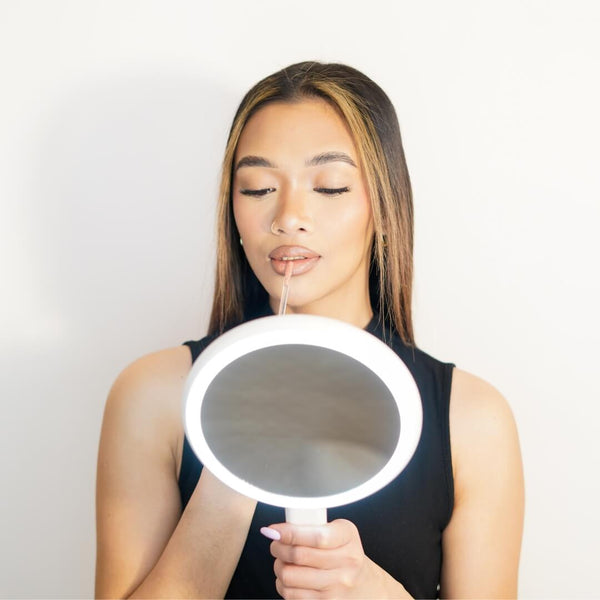 Cami handheld makeup vanity mirror features 3 dimmable led light by Fancii and Co All