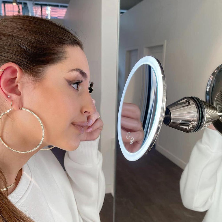 Woman using Fancii Lana 10x magnifying mirror with lights in ChromeWoman using Fancii Lana 10x magnifying mirror with lights in Chrome