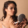 Applying Makeup with Fancii LUMI lighted compact in Silk White
