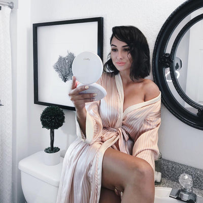 Applying Makeup with Fancii LUMI lighted compact in Rose Gold Midnight Black Silk White