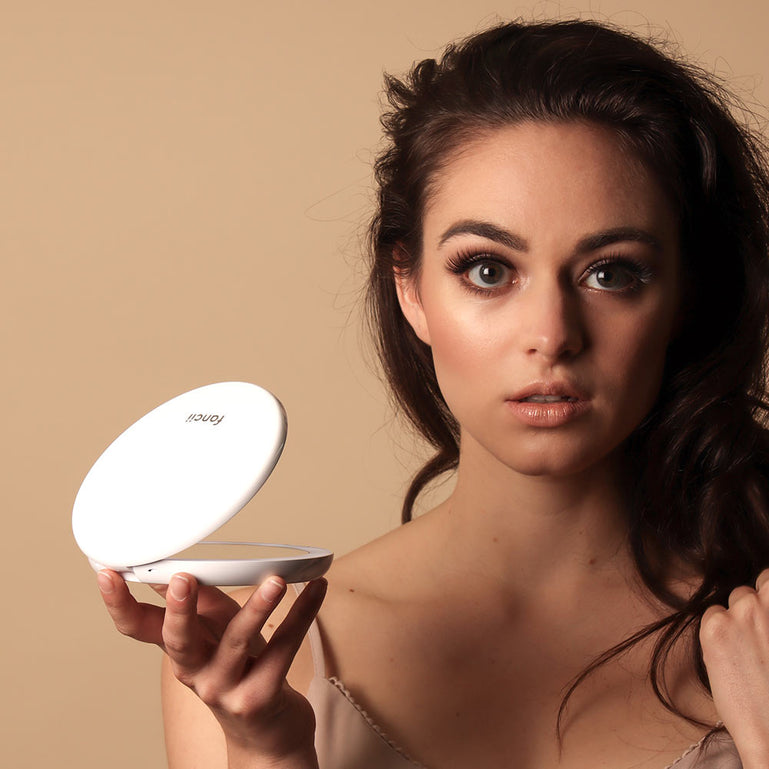 Applying Makeup with Fancii LUMI lighted compact in Silk White
