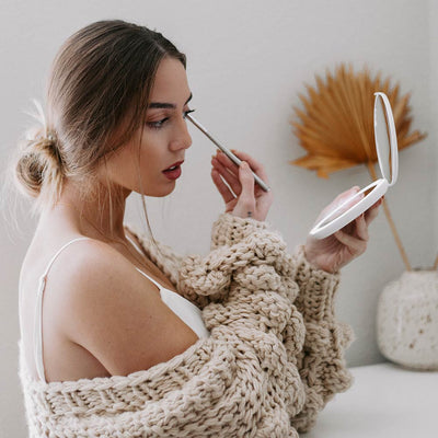 Applying Makeup with Fancii LUMI lighted compact in Silk White