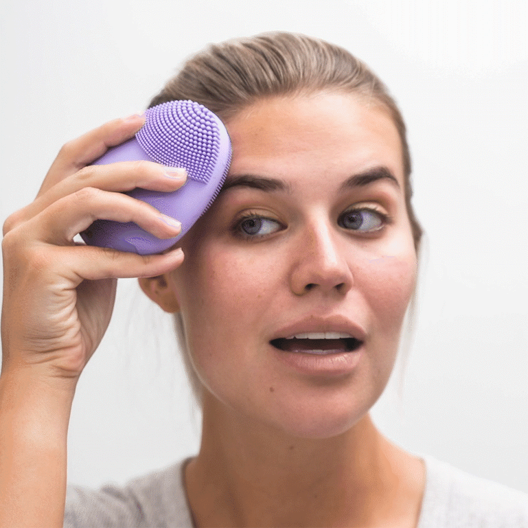 Washing face with Fancii Isla sonic facial cleansing brush Lavish All