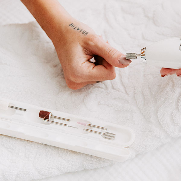 Woman doing her nails with Fancii Lola replacement nail drill bits