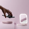 Mica Lighted Compact with built-in powerbank in Strawberry Cream color from Fancii & Co. showing the mirror and phone charging abilities.